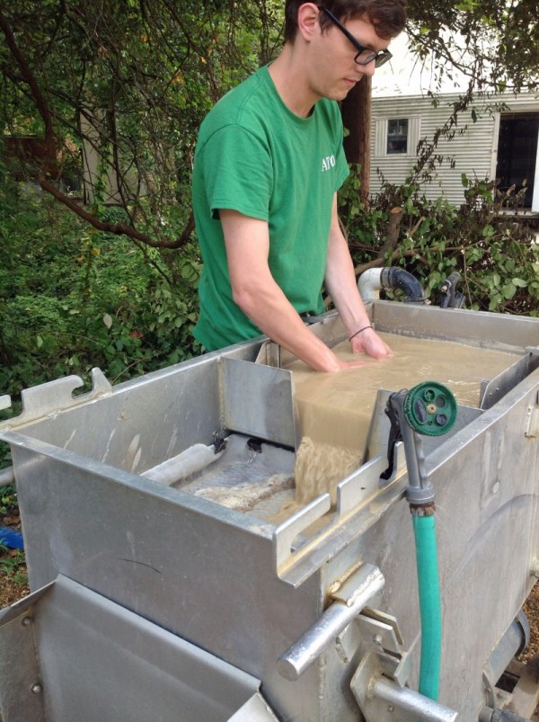 The flotation tank allows archaeologists to recover the smallest bits of evidence. Here, Ben processes a bag of soil from the summer's work. 