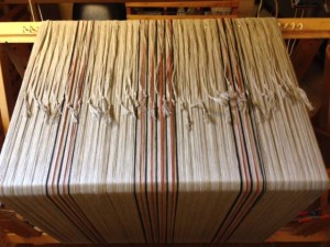 Textile during weaving (photo courtesy of Colonial Williamsburg Weaving and Dyeing Shop Facebook Page).