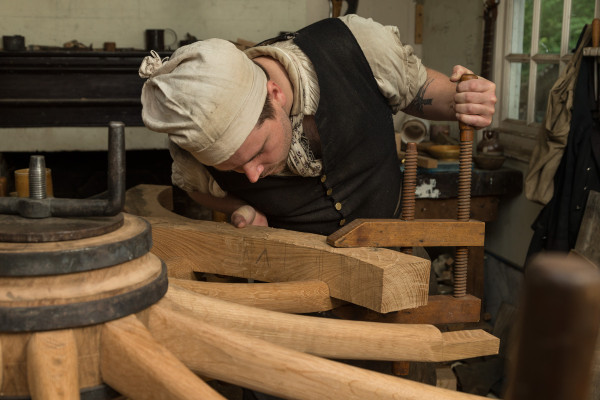 Andy De Lisle at the Wheelwright Shop working on a French cannon wheel being made for The Braintree Historical Society in Braintree, Massachusetts.  He’s putting the felloes on. Shot for Ben Swenson's Internet feature.  MODEL RELEASED