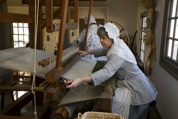 Karen Clancy weaving at the loom