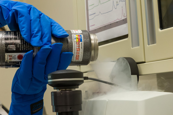 Materials Analysis lab for a Conservation blog. Kirstin Moffitt with the “FTIR microspectrometer demonstrates how we use it to ID materials.” To prep the instrument, liquid Nitrogen is poured into the detector to cool it to it's working temperature. MODEL RELEASED