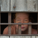 Emily Sullivan peers through a barred window at the Public Gaol.