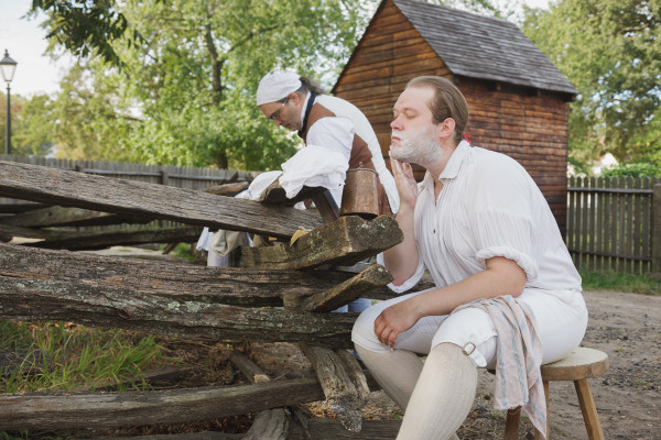 Timothy Logue applies some soap to his face while Joseph Delisle prepares for his shave