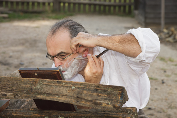 Tinsmith Joseph Delisle shaves with a straight razor outside the Public Armoury