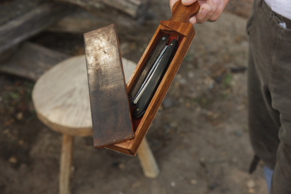 A straight blade for shaving in its wooden carrying case