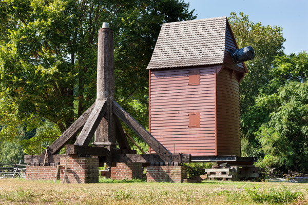 The windmill house sits next to its base and post prior to reassembly at Great Hopes Plantation