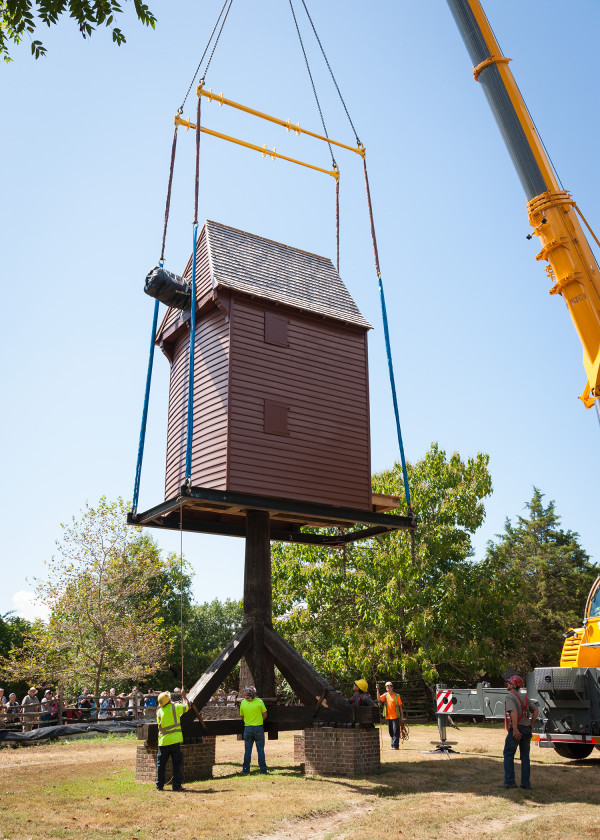 A crane lines up the windmill house with its post at Great Hopes Plantation.