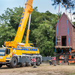 Crane lifting the windmill house on to the post at Great Hopes Plantation.