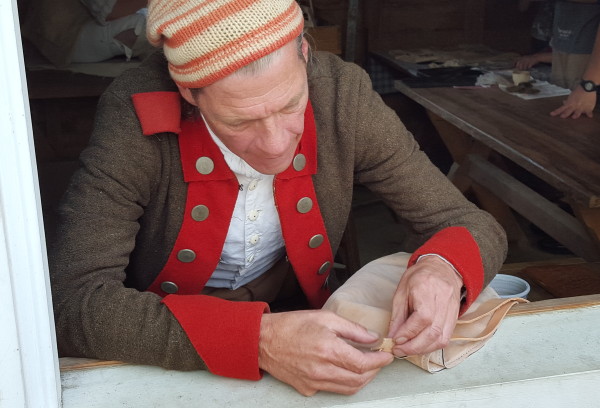 Military artificer Jay Howlett works on a pair of leather breeches