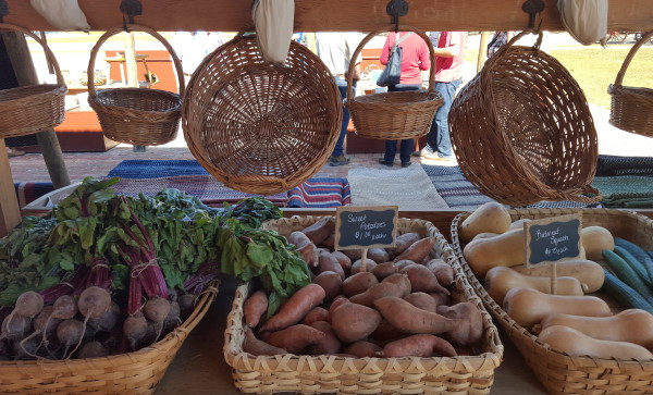 Fresh vegetables and handcrafted baskets for sale at the Market House