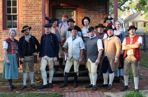 Historic Trades staff model their new leather breeches, and one leather stay