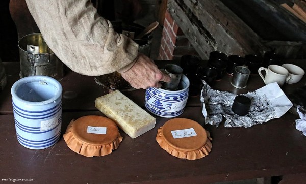 Shoemaker Rob Welch mixes a batch of black ball at Anderson's Blacksmith Shop.