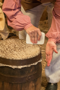 Cooper Ramona Vogel rubs sheep tallow on the skin on the African drum