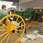 Paul Bennett (L) is assisted in assembly of the new sociable body for the Randolph Coach.