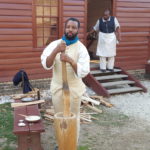 Marvin grinds corn at Randolph House