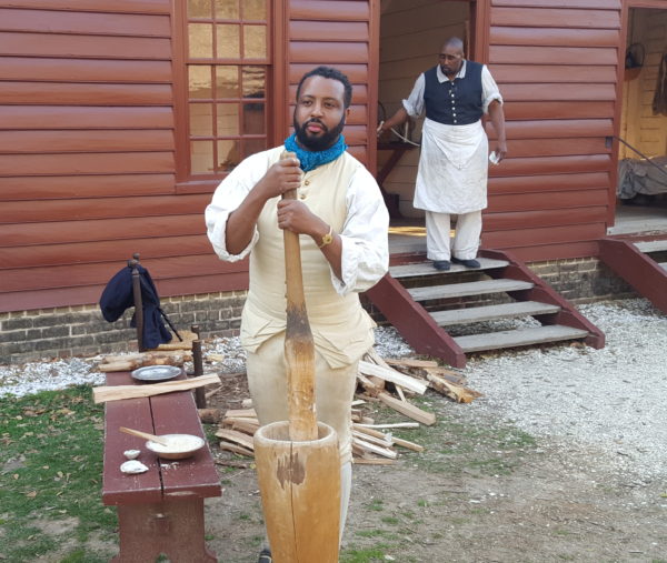 Marvin grinds corn at Randolph House