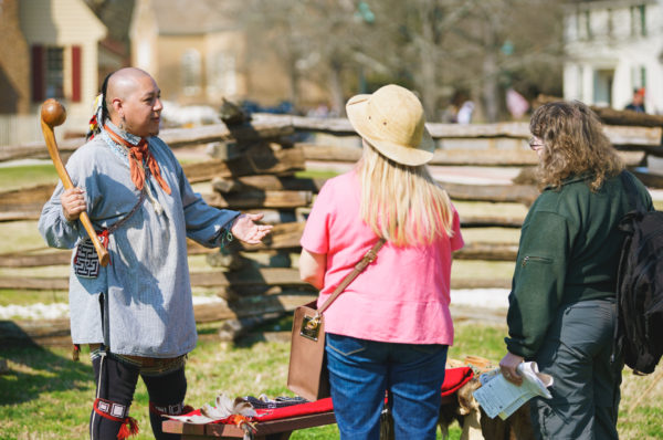 Kody talks to a guest at the Indian Encampment